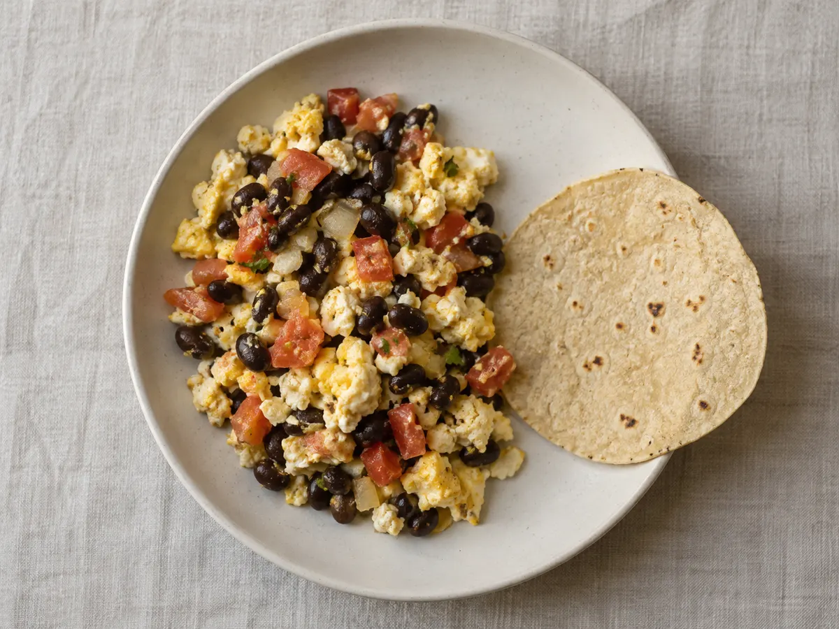 Scrambled eggs with beans and tomato, seen from above